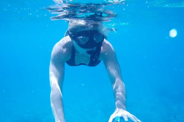 snorkeler on a La Jolla snorkel tour through the Ecological Reserve
