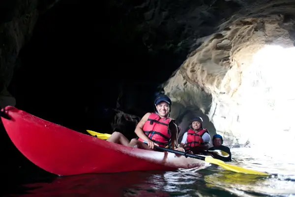 Two kayakers paddling through the 7 caves in the La Jolla area